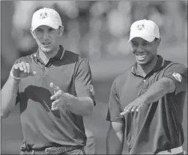  ?? David J. Phillip/the Associated Press ?? Dustin Johnson, left, and U.S. teammate Tiger Woods get a practice round in on Wednesday ahead of the start of the Ryder Cup at Medinah Country Club.