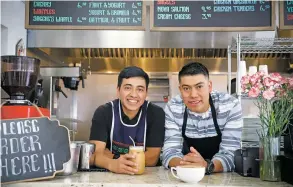  ??  ?? From left, Erwin and Walfre Sagche behind the counter of the new Sagche’s Coffee House, which specialize­s in an array of breakfast items including crepes, breakfast burritos, waffles and omelets, New Mexican favorites, and coffee favorites such as a latte, below. Sagche’s Coffee House is located in a shopping center on St. Michael’s Drive and Pacheco Street.