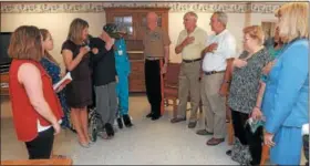  ?? GENE WALSH — DIGITAL FIRST MEDIA ?? Family and staff stand during playing of Marine Corps hymn at ceremony honoring World War II veteran Louis Rittelmann at Phoenixvil­le Care and Rehab Center.