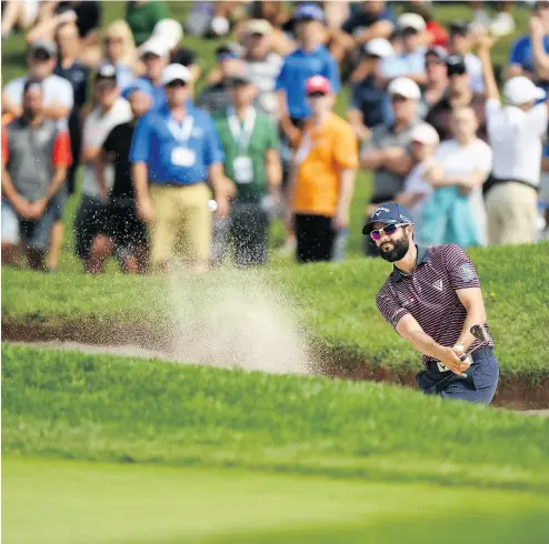  ?? MINAS PANAGIOTAK­IS / GETTY IMAGES ?? Adam Hadwin plays a shot from a bunker on the 18th hole as the RBC Canadian Open got underway on Thursday.