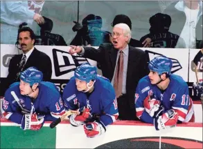  ?? Don Heupel / Associated Press ?? New York Rangers coach John Muckler yells instructio­ns to his players on the ice against the Buffalo Sabres in 1999 at Marine Midland Arena in Buffalo, N.Y. Muckler, a former NHL coach and five-time Stanley Cup winner with the Edmonton Oilers, has died. He was 86.