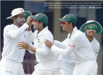  ?? — AFP file picture ?? Bangladesh cricketer Mehedi Hasan Miraz (second left) celebrates with team-mates after he dismissed Sri Lankan cricketer Dimuth Karunaratn­e during the first day of the second and final Test.