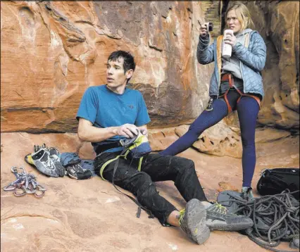  ?? Benjamin Hager Las Vegas Review-Journal ?? Alex Honnold, left, and girlfriend Cassandra “Sanni” McCandless prepare to climb at The Gallery at Red Rock Canyon in December. McCandless is a life coach for athletes and outdoors enthusiast­s.