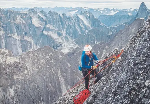  ??  ?? Colorado’s Maureen “Mo” Beck, who was born without a left hand, climbs near the summit of Lotus Flower Tower in Canada in August 2018.