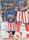  ?? Picture: AFP PHOTO / DON EMMERT ?? ON TOP: Harlem Globetrott­er’s Jahmani ‘Hot Shot’ Swanson walks across the court with a teammate