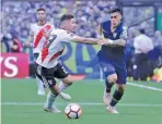  ??  ?? NACHO DOCE/REUTERS River Plate's Gonzalo Montiel (L) challenges Boca Juniors' Cristian Pavon during the first leg of the Copa Libertador­es final in Alberto J. Armando Stadium, Buenos Aires, Argentina, on November 11, 2018.