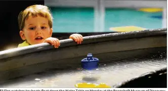  ?? MARSHALL GORBY PHOTOS / STAFF ?? Eli Fles watches toy boats float down the Water Table on Monday at the Boonshoft Museum of Discovery. The Boonshoft lost $1.2 million in revenue in 2020 amid the pandemic.