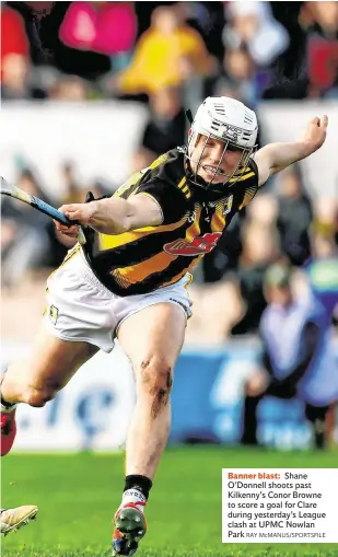  ?? RAY McMANUS/SPORTSFILE ?? Banner blast: Shane O’Donnell shoots past Kilkenny’s Conor Browne to score a goal for Clare during yesterday’s League clash at UPMC Nowlan Park