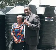  ?? PHOTO BY ORANTES MOORE ?? Mary Sewell of Derry Basic School in St Mary accepts a 600-gallon water storage tank from St Mary Western Member of Parliament Robert Montague.
