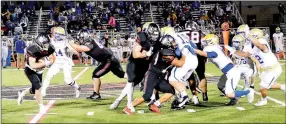  ?? Photograph courtesy of Samantha Huffman ?? Blackhawk senior Thaddeus Timmons (No. 63) held off a Harrison Goblin protecting the ball carrier as junior Joe Adams (No. 2) ran the ball. Adams had the best rushing night of his career, picking up 184 yards on 27 carries Friday, Nov. 6. For more photograph­s, go to https://tnebc.nwaonline.com/photos/.