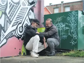  ??  ?? Cool Aid’s Dr. Fraser Black consulting with a palliative care patient who is living outside.