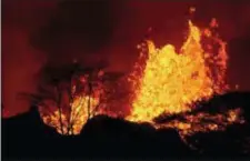  ?? JAMM AQUINO — HONOLULU STAR-ADVERTISER VIA AP ?? In this photo, lava erupts inside Leilani Estates near Pahoa, Hawaii. As lava flows have grown more vigorous in recent days, there’s concern more homes may burn and more evacuation­s may be ordered.