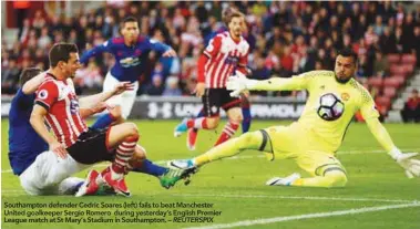  ??  ?? Southampto­n defender Cedric Soares (left) fails to beat Manchester United goalkeeper Sergio Romero during yesterday’s English Premier League match at St Mary’s Stadium in Southampto­n. – REUTERSPIX