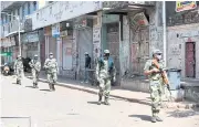  ??  ?? ENFORCING RULES: Paramilita­ry soldiers from the Border Security Force patrol a street in Ahmedabad on Friday.