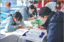  ?? CHINA DAILY PROVIDED TO ?? Visitors turn their hands to making murals with traditiona­l methods at the Fahai Temple Mural Art Center in December 2023.