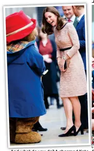  ??  ?? And what do you do? A charmed Kate meets Paddington Bear yesterday FeelingF swell: A hint of the duchess’s baby bump is on show