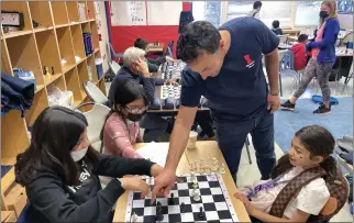  ?? SHERRY LAVARS — MARIN INDEPENDEN­T JOURNAL ?? Hamilton School students practice Thursday at the campus in Novato. From left: Sofia Diaz; her sister Valentina Diaz; chess coach Abel Talamantez; and Shalimar Arevalo.