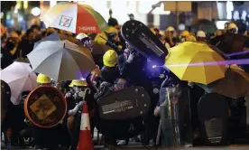  ??  ?? Protesters shine a laser beam during a confrontat­ion with police. Photograph: Vincent Thian/AP