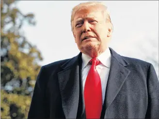  ??  ?? President Donald Trump pauses as he talks to media before boarding Marine One on the South Lawn of the White House in Washington, Saturday, for the short trip to Andrews Air Force Base en route to Philadelph­ia to attend the Army-Navy Football Game.