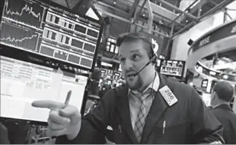  ?? NEW YORK
-AP ?? Trader Michael Milano works on the floor of the New York Stock Exchange.