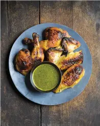  ?? Milk Street ?? ■ Chutney-glazed spatchcock­ed chicken. Spatchcock­ing, or butterflyi­ng, involves cutting out a bird’s backbone so it can be flattened. This allows the chicken to brown evenly and helps the glaze stay put. Their simple glaze mixes tangy-sweet chutney with butter and turmeric. Citrus juice added to a portion of the glaze before cooking makes a bright dipping sauce.