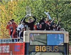  ?? PETER CASEY/USA TODAY SPORTS ?? GM Mike Rizzo lifts the Commission­er’s Trophy during the Nationals’ World Series championsh­ip parade Saturday in D.C.