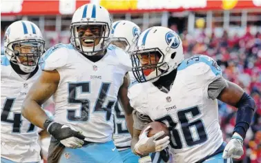  ?? THE ASSOCIATED PRESS ?? Titans linebacker Avery Williamson, center, and teammates celebrate after cornerback LeShaun Sims, right, intercepte­d a pass during the second half of their 19-17 victory over the Kansas City Chiefs in Kansas City, Mo., Sunday.