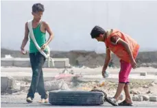  ?? — AFP ?? Yemeni youth set tyres on fire as protesters demonstrat­e against inflation and the rise of living costs in the city of Aden on Saturday.