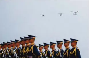  ??  ?? PAMPANGA: Philippine troops stand at attention as Presidenti­al choppers bearing Philippine President Rodrigo Duterte prepare to land for the 70th anniversar­y celebratio­n of the Philippine Air Force at Clark Freeport Zone yesterday in Pampanga province,...