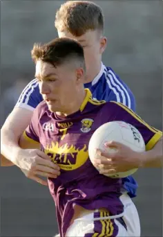  ??  ?? Wexford captain Ciarán Kavanagh is tackled by Seán Michael Corcoran of Laois during Wednesday’s encounter.