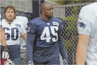  ?? STAFF PHOTO BY JOHN WILCOX ?? WELCOME ADDITION: New Patriots linebacker Davis Harris, who was signed as a free agent in the offseason, walks onto the practice field yesterday.