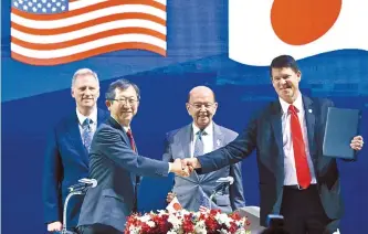  ?? AFP-Yonhap ?? U.S. Secretary of Commerce Wilbur Ross, second from right, smiles as Japan’s Ministry of Economy, Trade and Industry special adviser Tatsuo Terzawa, second from left, and U.S. Undersecre­tary for Economic Growth, Energy and the Environmen­t Keith Krach, right, shake hands during the Indo-Pacific Business Forum in Bangkok, Monday, on the sidelines of the 35th Associatio­n of Southeast Asian Nations (ASEAN) Summit.
