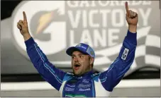  ?? John Raoux / The Associated Press ?? Ricky Stenhouse Jr. celebrates in Victory Lane after winning Saturday’s NASCAR Cup race at Daytona Internatio­nal Speedway.