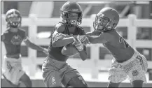  ?? NWA Democrat-Gazette/BEN GOFF • @NWABENGOFF ?? Chad Graham, Elkins wide receiver, catches a pass under pressure from Christion Wise on Friday during the Southwest Elite 7on7 Showcase at Jarrell Williams Bulldog Stadium in Springdale.