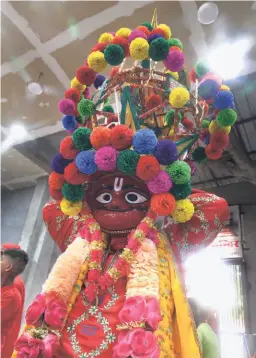  ?? ?? NARINDER KUMAR SURI, leader of one of the Bajrangi Sena groups that go around the smaller temples in the area and the Bada Hanuman temple during the mela. His mask, he says, is more than 400 years old and has been with his family for four generation­s.