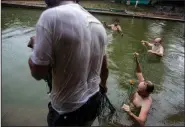  ?? The Associated Press/FRANKLIN BRICENO ?? Father Zabala fishes with residents in a pool he converted into a natural pond to grow fish for consumptio­n in Boca Colorado, part of Peru’s Madre de Dios region in the Amazon. The 70-year-old Spanish priest says he is a fisher of men as Jesus as asked.