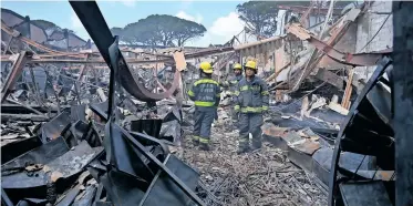  ?? | AYANDA NDAMANE African News Agency (ANA) ?? THE buildings housing HDC Home Department Store, CAB Foods and the AMG dealership were ravaged by the fire near Access Park in Kenilworth.