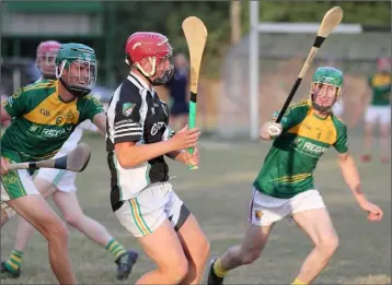  ??  ?? Gavin Watchorn about to strike for Hollow Rovers in their Under-20 win in Farmleigh on Wednesday despite the best efforts of HWH-Bunclody duo John Dunne and Jamie Kavanagh.