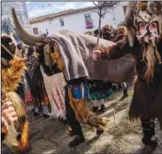  ?? ?? A man dressed as “Vaca-Tora” drives away “Carantonas” on Jan. 21 during the festival.