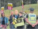  ??  ?? Stand Up to Racism Scotland activists protest at Turnberry.