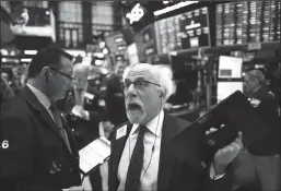  ?? TRIBUNE NEWS SERVICE ?? Traders work during the opening bell at the New York Stock Exchange.