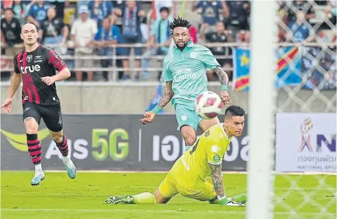  ?? ?? Buriram United’s Jonathan Bolingi scores their first goal against Bangkok United during the FA Cup final last night.