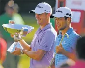  ?? CURTIS COMPTON/ATLANTA JOURNAL-CONSTITUTI­ON VIA AP ?? Justin Thomas, left, holds the trophy Sunday after winning the Fedex Cup, as he stands with Xander Schauffele, who holds the trophy after winning the Tour Championsh­ip at East Lake Golf Club in Atlanta.