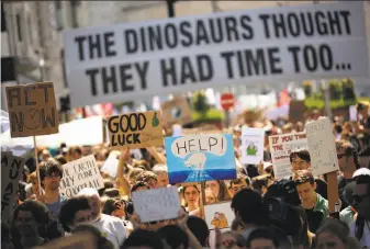  ?? Francisco Seco / Associated Press ?? People march during a climate protest in Brussels. Demonstrat­ors are demanding tougher action against global warming, as the 28-nation bloc votes to fill the European Parliament.