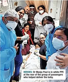  ?? ?? HEROES: Dr Manju Paul is in white PPE at the rear of the group of passengers who helped deliver the baby.