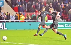  ??  ?? Manchester City’s Belgian midfielder Kevin De Bruyne (R) shoots to score their late winning goal during the English League Cup semi-final, second leg football match between Bristol City and Manchester City at Ashton Gate Stadium in Bristol, south-west...