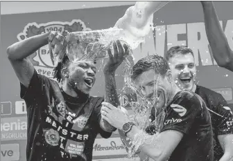  ?? AP ?? Leverkusen head coach Xabi Alonso is sprayed with beer as players and management celebrate winning the German Bundesliga title on Sunday.