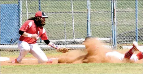  ?? PHOTOS BY RICK PECK ?? McDonald County’s Jaime Hanke slides into third base hidden by a cloud of dust to beat a throw during the Mustangs 12-0 win over Locust Grove at last week’s Mickey Mantle Wood Bat Tournament in Commerce, Okla.
