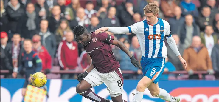  ?? Picture: SNS ?? CHALLENGE: Kilmarnock’s central defender Stuart Findlay fouls Hearts midfielder Prince Buaben inside the 18-yard box in the 6th minute which resulted in Jamie Walker opening the scoring.