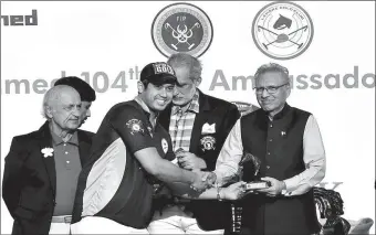  ?? -APP ?? President Dr. Arif Alvi giving away shields among the players during prize distributi­on of Gul Ahmed FIP 104th Ambassador’s Polo Cup 2019 at Polo Club.